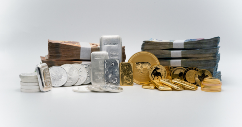 A heap of banknotes, coins and bars made of silver